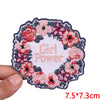 Pink and red floral embroidery patch with the text Girl Power on a white fabric background
