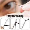 Close-up of a sewing needle being threaded with dark thread, demonstrating easy threading.