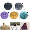 Six-tone steel tongue drum hand pan in purple, yellow, and teal colors with wooden mallets.