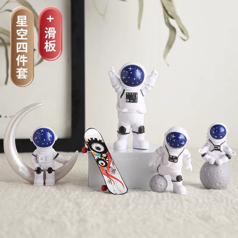 A set of handcrafted astronaut figurines and resin spaceman desk decor items displayed on a white surface.