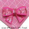 Pink sequin bow patches for DIY crafts displayed on a pink grid background.