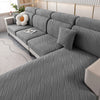 Asiento y funda elástica gris removible con textura ondulada, mostrada en interiores.