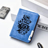 A blue leather wallet with black text featuring a stylized design, placed next to a silver metal card holder.