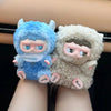A pair of fluffy blue and white collectible blind box keychains featuring cute animal characters.