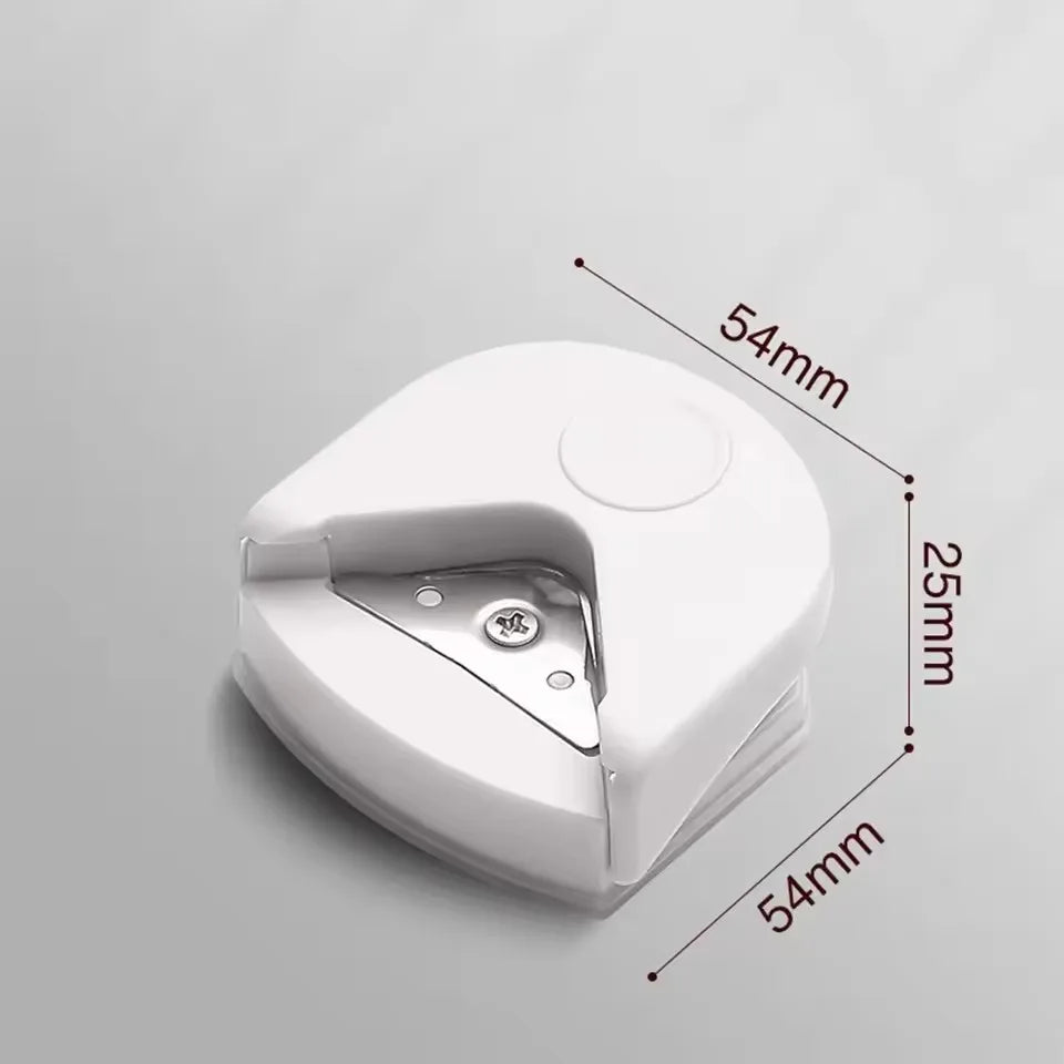A white paper corner rounder cutter with dimensions marked, shown from a top-down angle.