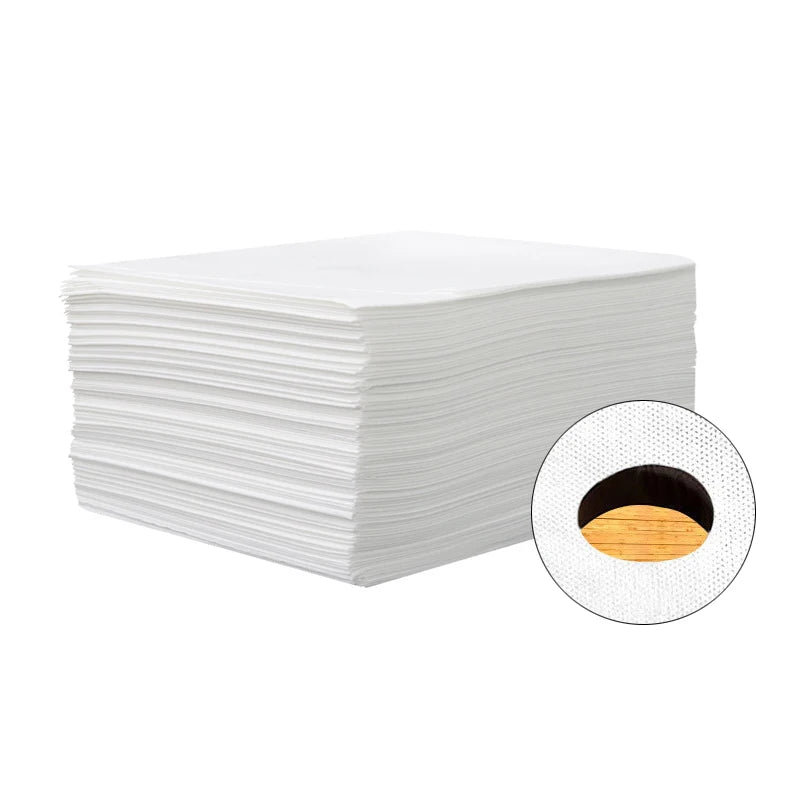 A stack of white disposable bed sheets for salons, spas, and travel.