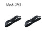 A pair of black cord organizers or wire winders for tidy cable management.