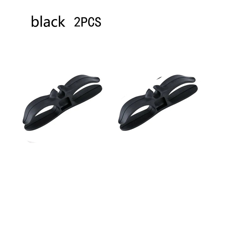 A pair of black cord organizers or wire winders for tidy cable management.