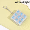 A clear silicone fidget toy keychain with blue LED lights shaped like a diamond and square pattern.