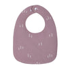 A mauve baby bib with a U-shaped design featuring small white tree patterns.