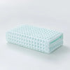 A stack of light mint green waffle weave bath towels folded neatly on a white surface.