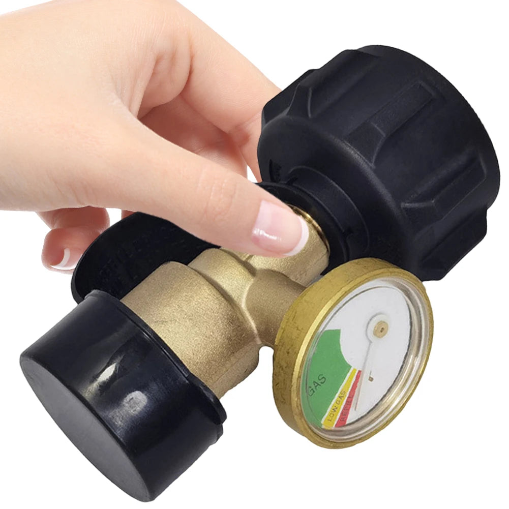 A hand is holding a black digital propane tank gauge with a leak detector and a brass-colored valve.