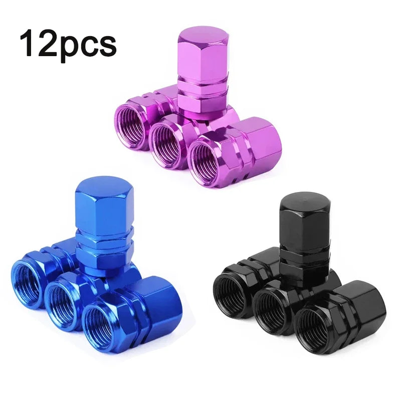 A set of four metal valve caps in various colors including pink, purple, and blue, featuring a hexagon design.