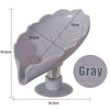 Gray leaf-shaped suction cup soap dish with a self-draining tray and stand.