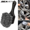 A black car cleaning brush set featuring a bristled brush and a glove for detailing wheels.