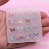 A clear silicone mold containing multiple butterfly shapes for DIY epoxy resin jewelry making.
