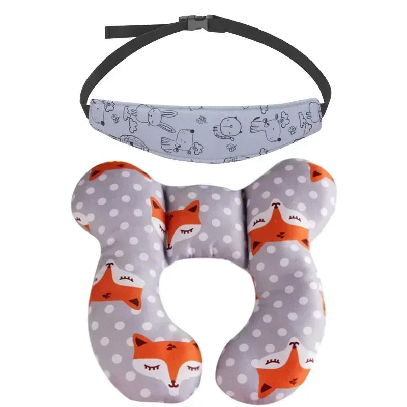 A gray and white patterned baby head and neck support pillow with an orange fox design and a black safety strap.