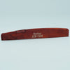 A wooden acoustic guitar bridge saddle with the inscription GUYKOAT ATR-7239