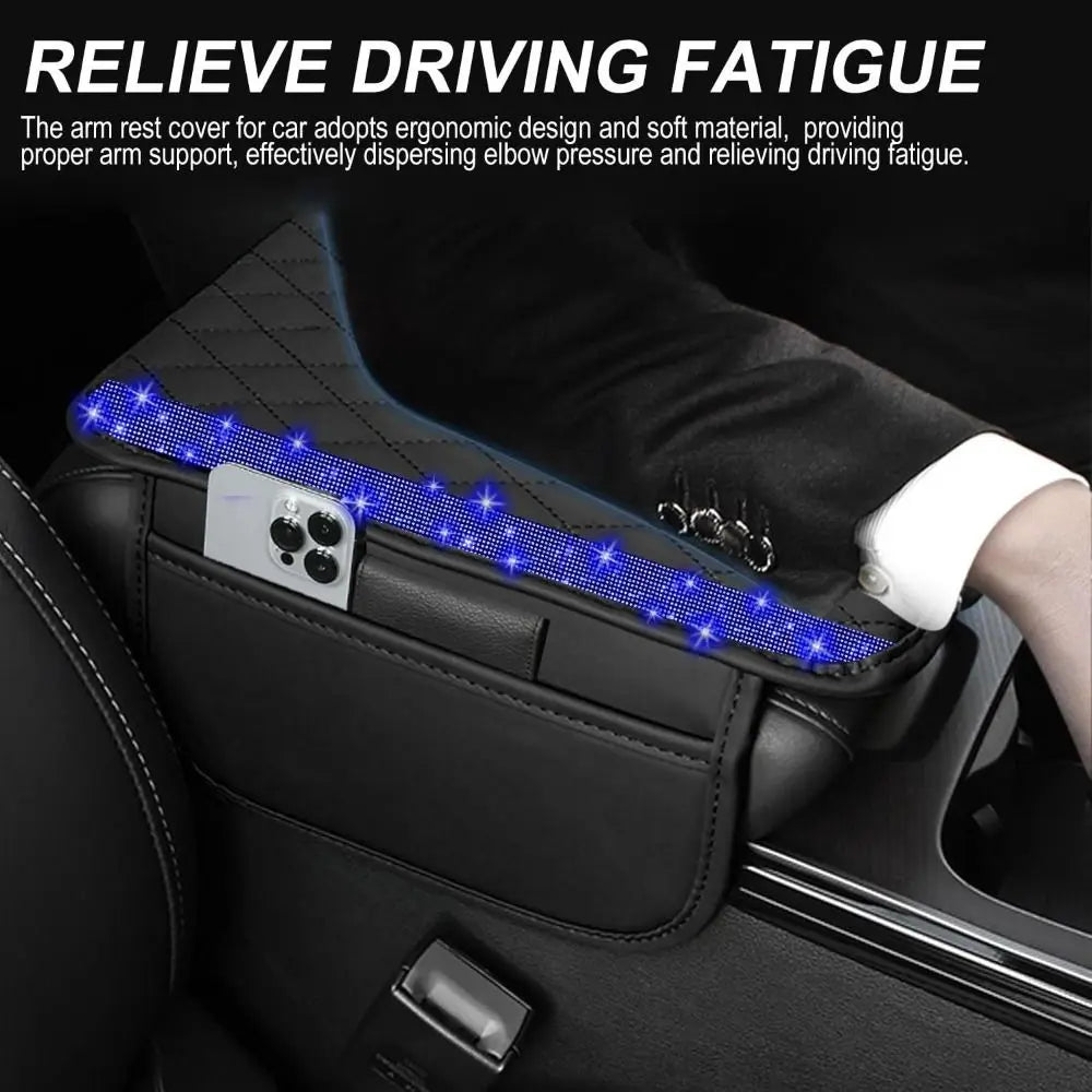 A black quilted car armrest cover with blue LED lighting is shown inside a car, designed to relieve driving fatigue.