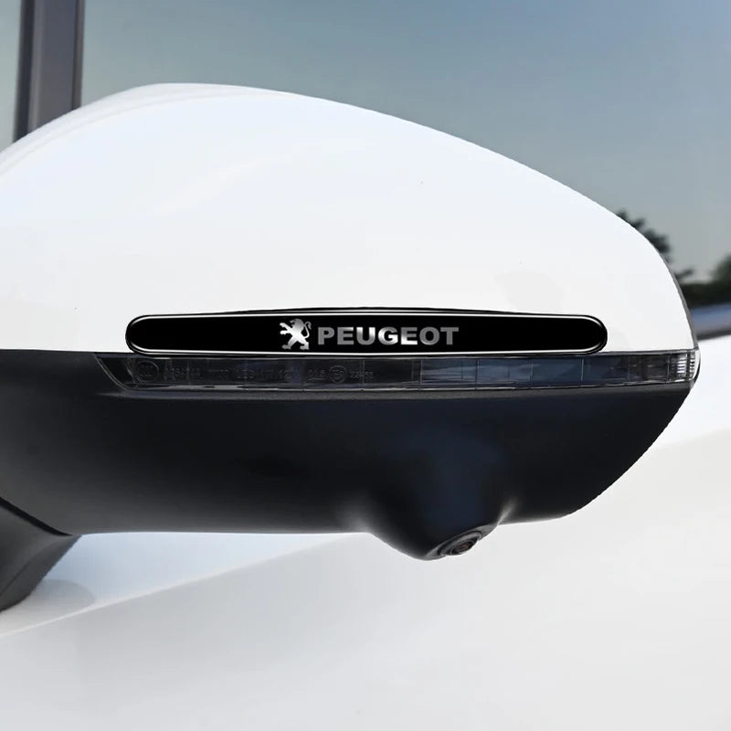 Close-up of a white car door handle bowl with a black Peugeot logo film applied to the glass.