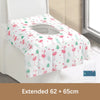 White and pink floral patterned disposable toilet seat covers displayed on a white toilet seat.