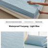 Light blue waterproof fitted mattress protector shown on a bed, highlighting its soft and clean features.