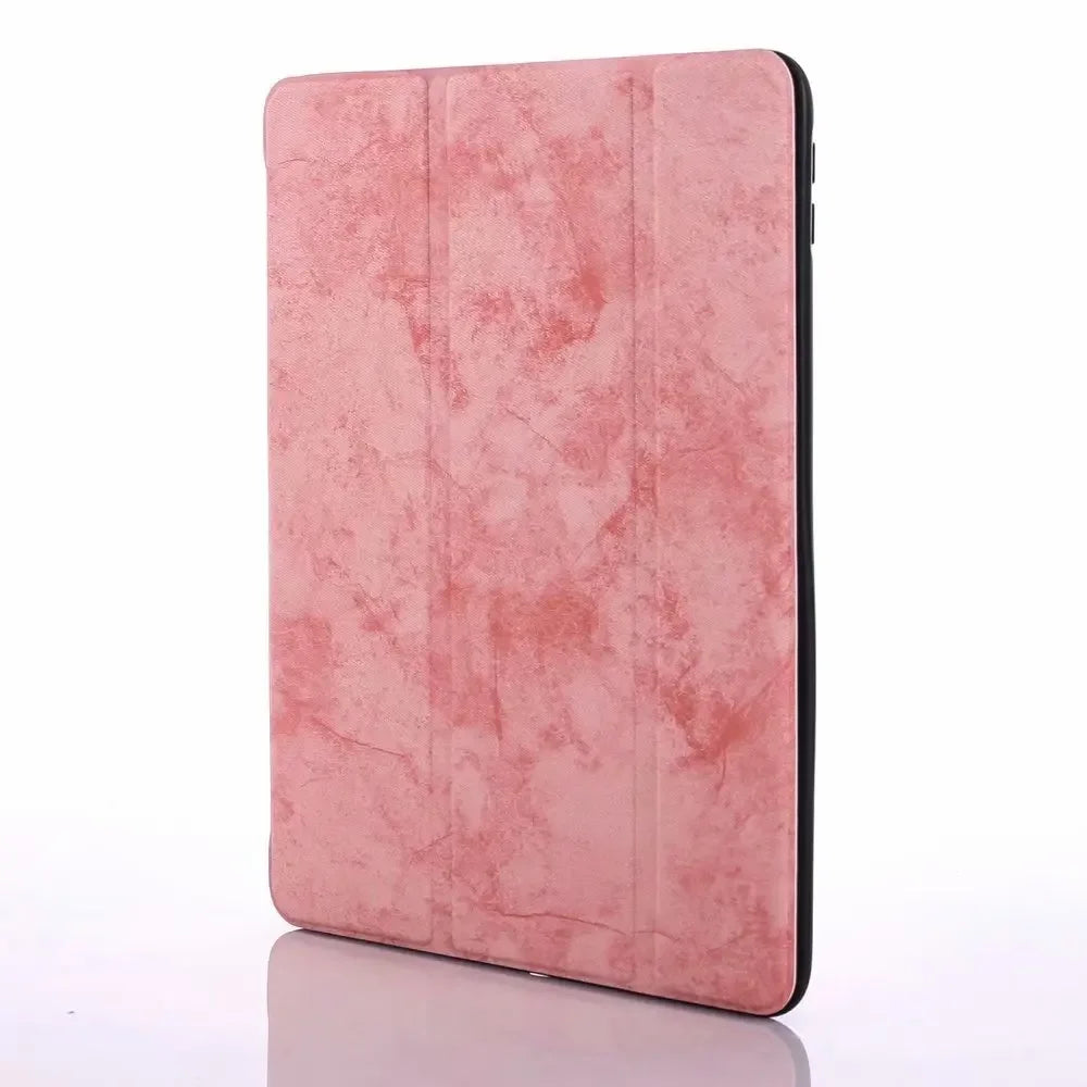 A pink retro marble case for an iPad Pro 12.9 with a built-in pencil holder.