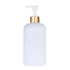 A white refillable soap dispenser bottle with a gold pump top.