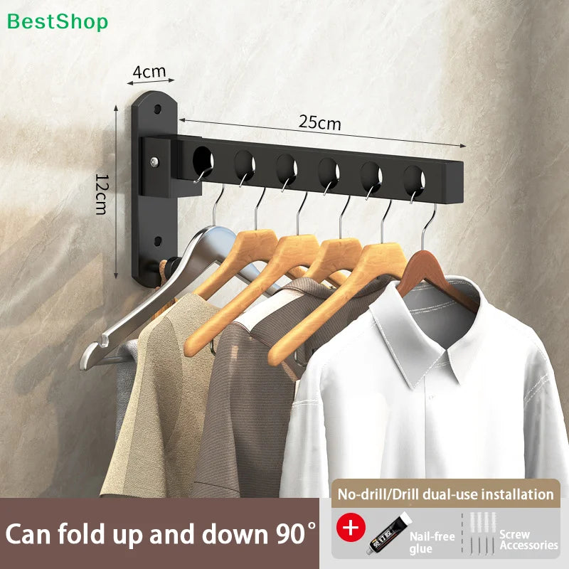 Black foldable wall-mounted clothes drying rack with hangers installed on a beige wall.