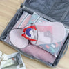A gray storage box contains several reusable mesh laundry bags for shoes and delicates.