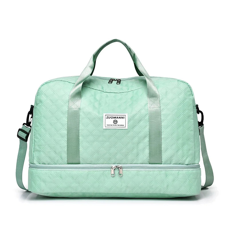 A mint green lightweight nylon travel duffle bag with light green quilted fabric and a canvas logo.