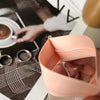 A hand holds a pink self-sealing jewelry storage bag, showcasing the clear pouch inside.