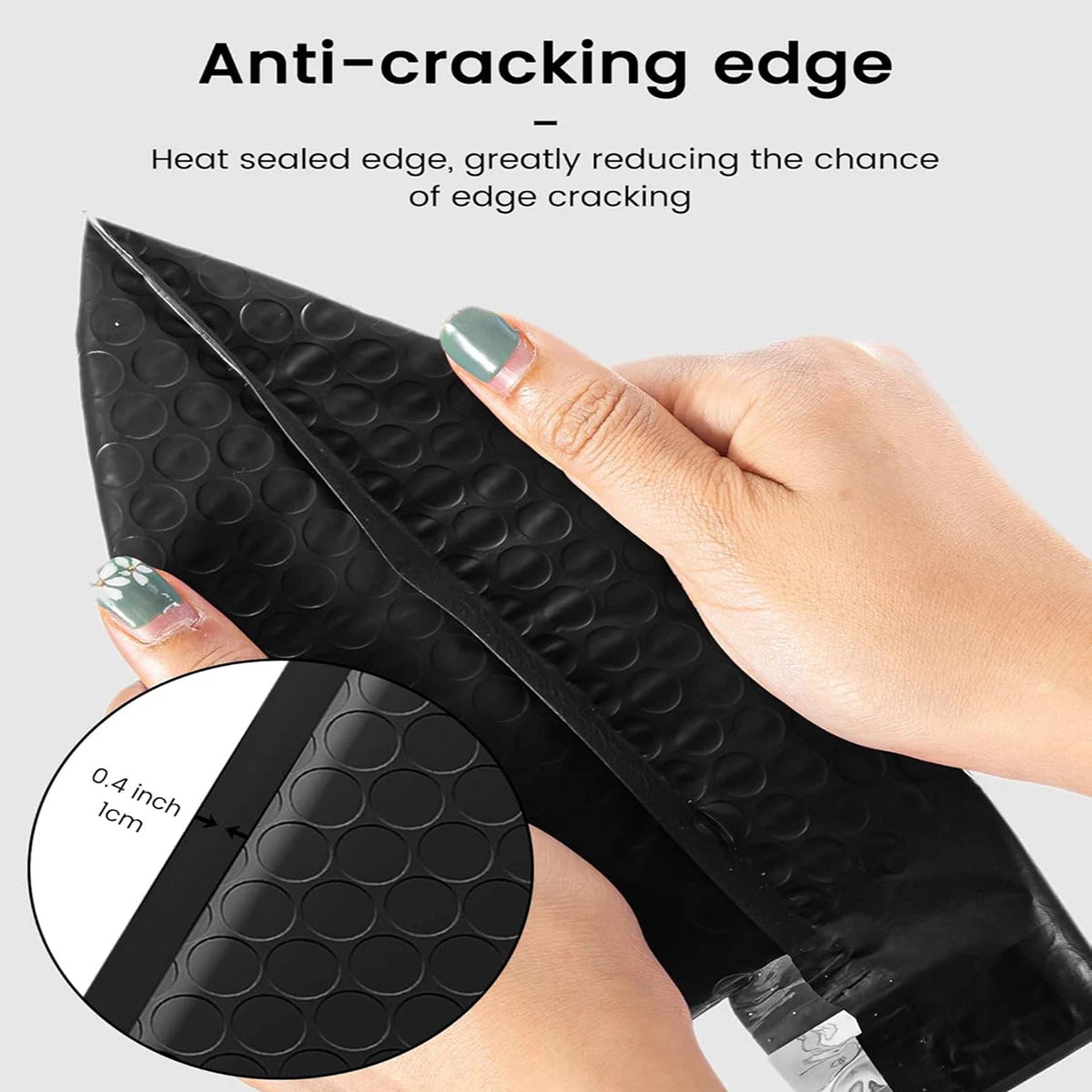 A hand holds a black anti-cracking edge bubble mailer, showing its thickness and sealing feature.
