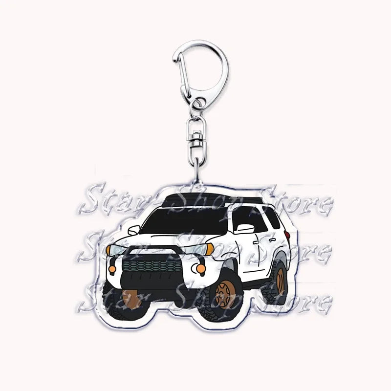A silver metal key ring attached to a durable keychain featuring an off-road truck silhouette.