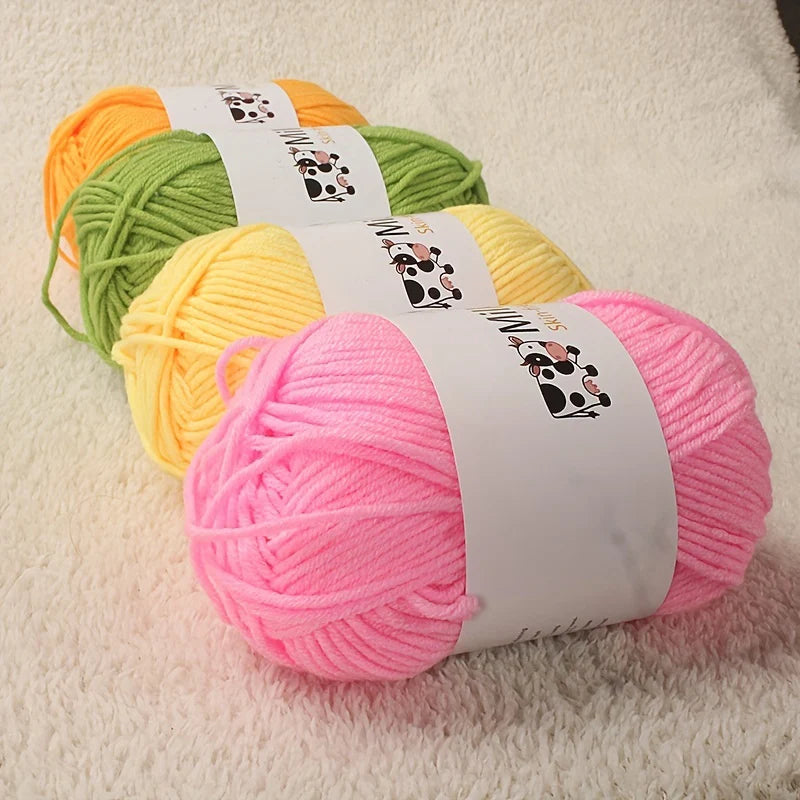 A collection of bright colored acrylic yarn skeins, including green, yellow, and pink, displayed on a white surface.