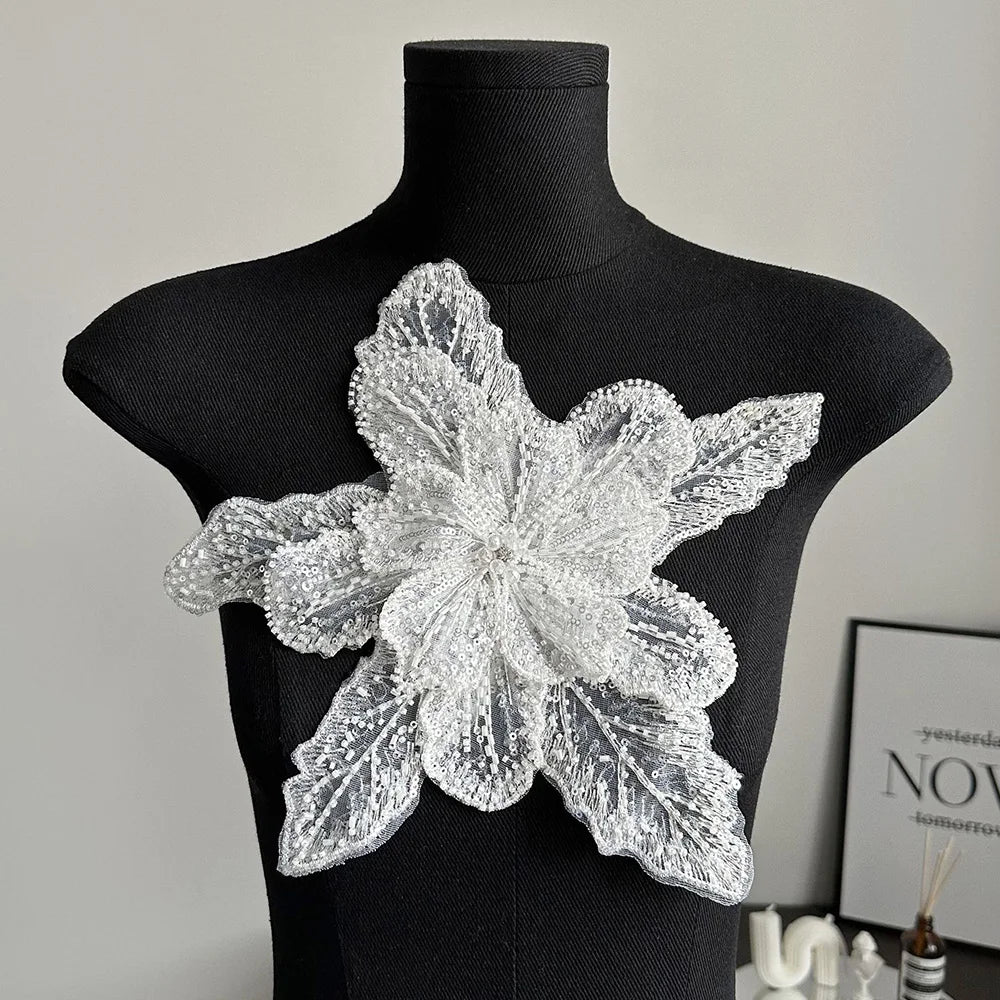 Silver sequin floral lace applique patch displayed on a black mannequin.