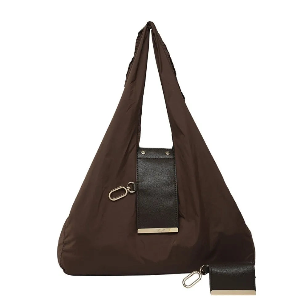 A dark brown retractable keychain tote bag folded into a compact pouch with a leather accent.
