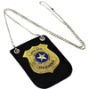 A gold police badge with a star emblem is displayed on a black background, attached to a silver chain and clip.