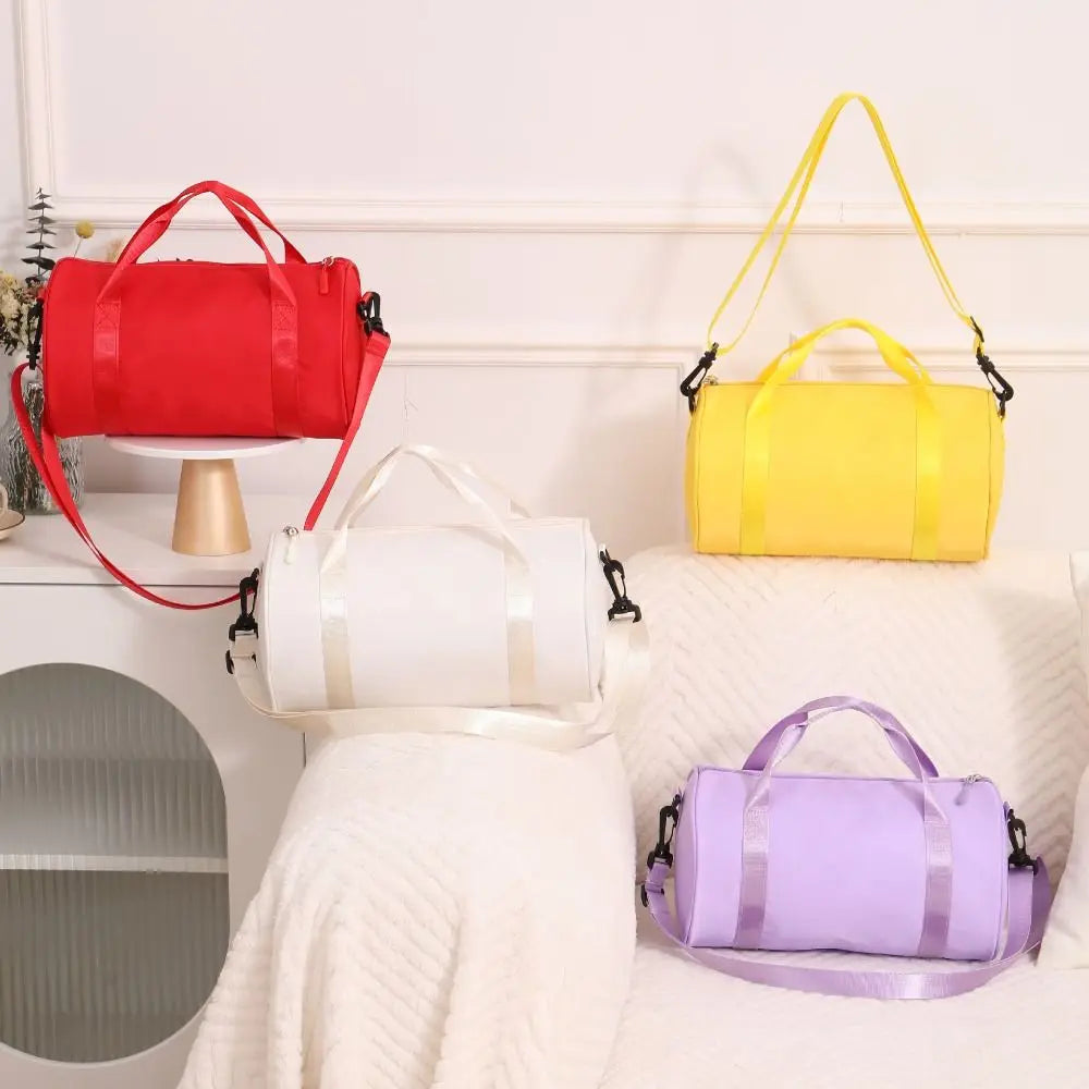 Three brightly colored nylon gym bags—red, yellow, and purple—are displayed on a white surface.