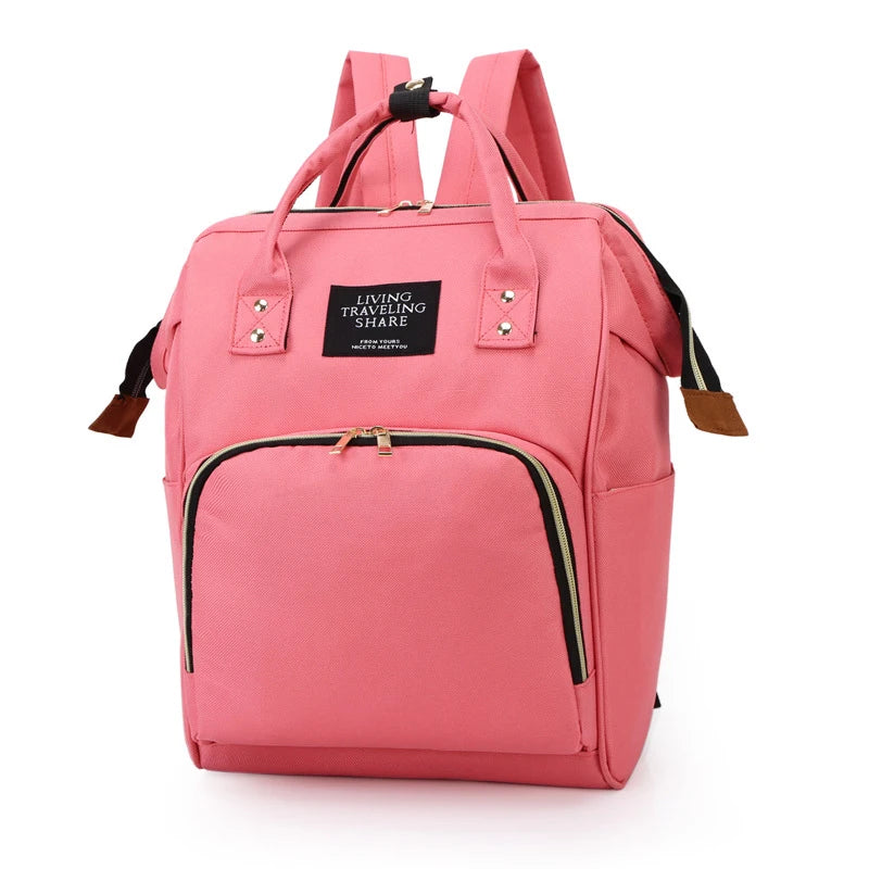 Pink insulated canvas mummy diaper bag with a hanging hook and zippered pocket