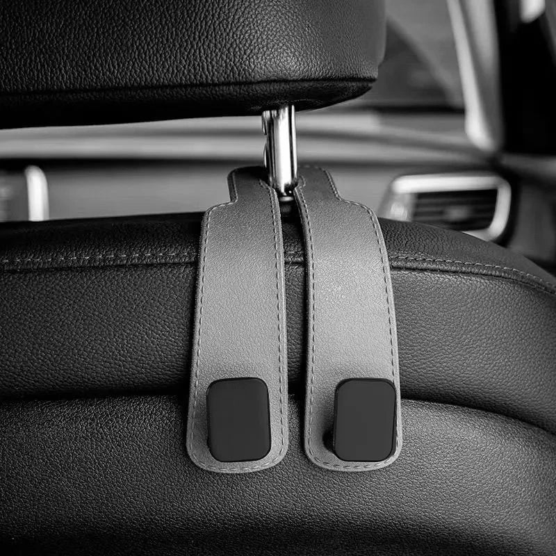 Close-up of car headrest hooks designed for hanging bags and shopping organizers.