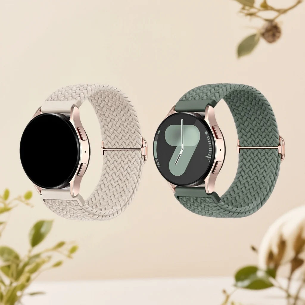 A watch with a silver-toned case and a braided nylon strap in light gray and sage green colors.