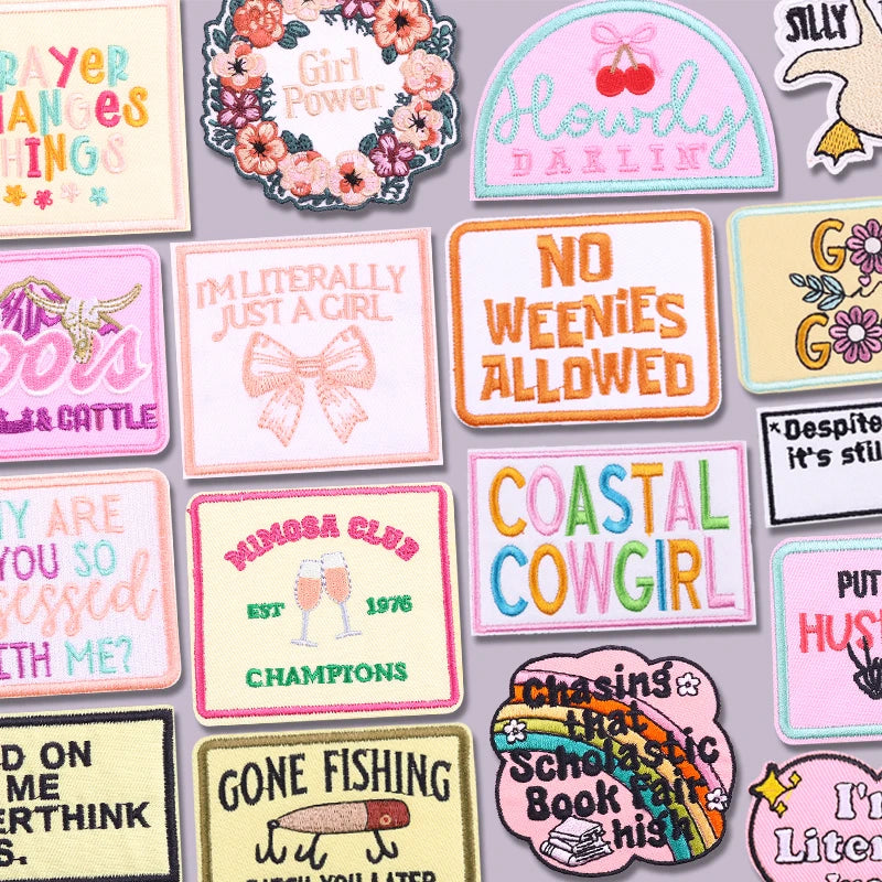A collection of colorful letter embroidered patches for jackets and clothing featuring words like Girl Power No Weenies Allow