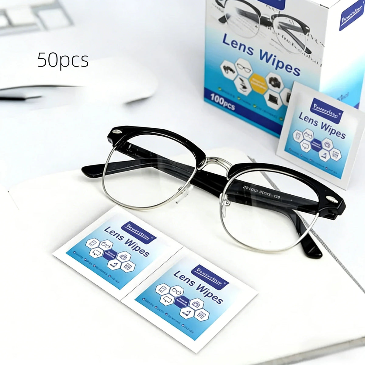 A set of individually wrapped lens wipes for cleaning glasses, including a pair of black-framed eyeglasses.