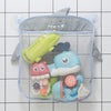 A gray mesh bag with a duck face design holds various bath toys including a yellow duck, a blue fish, and other plastic toys.