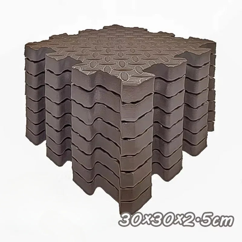 Eight interlocking foam play mats stacked in a square formation, brown color.