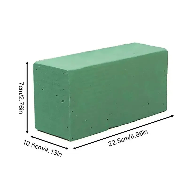 A rectangular block of green floral foam with dimensions 7cm x 2.76in by 10.5cm x 4.13in.