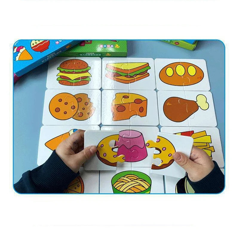 A hand is holding several colorful puzzle cards featuring various food items like hamburgers, fruits, and vegetables on a blu