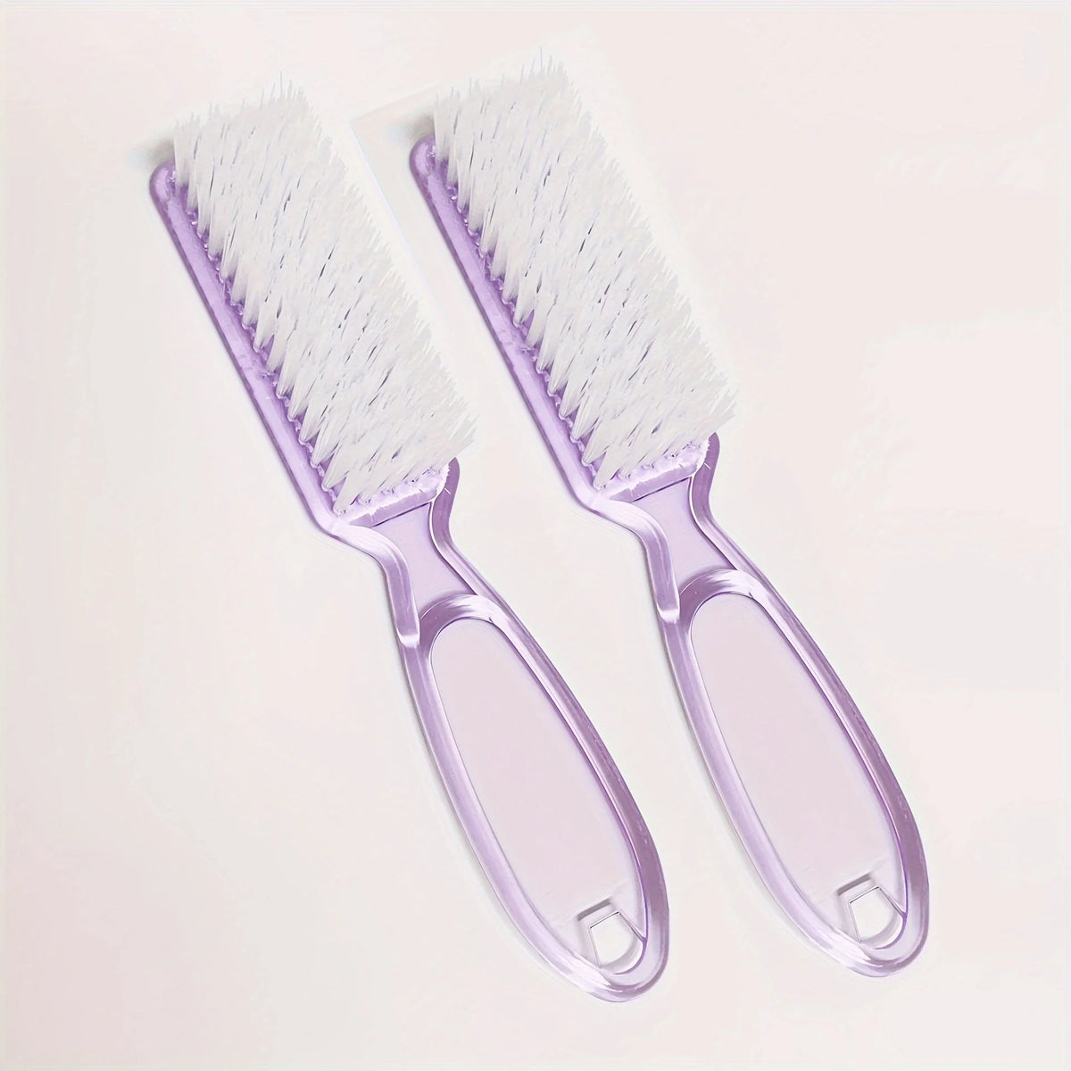 A pair of purple nail art brushes with long handles are shown against a light background.