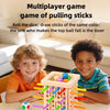 Two smiling boys play a family pick-up sticks game with colored sticks and balls on a wooden board.